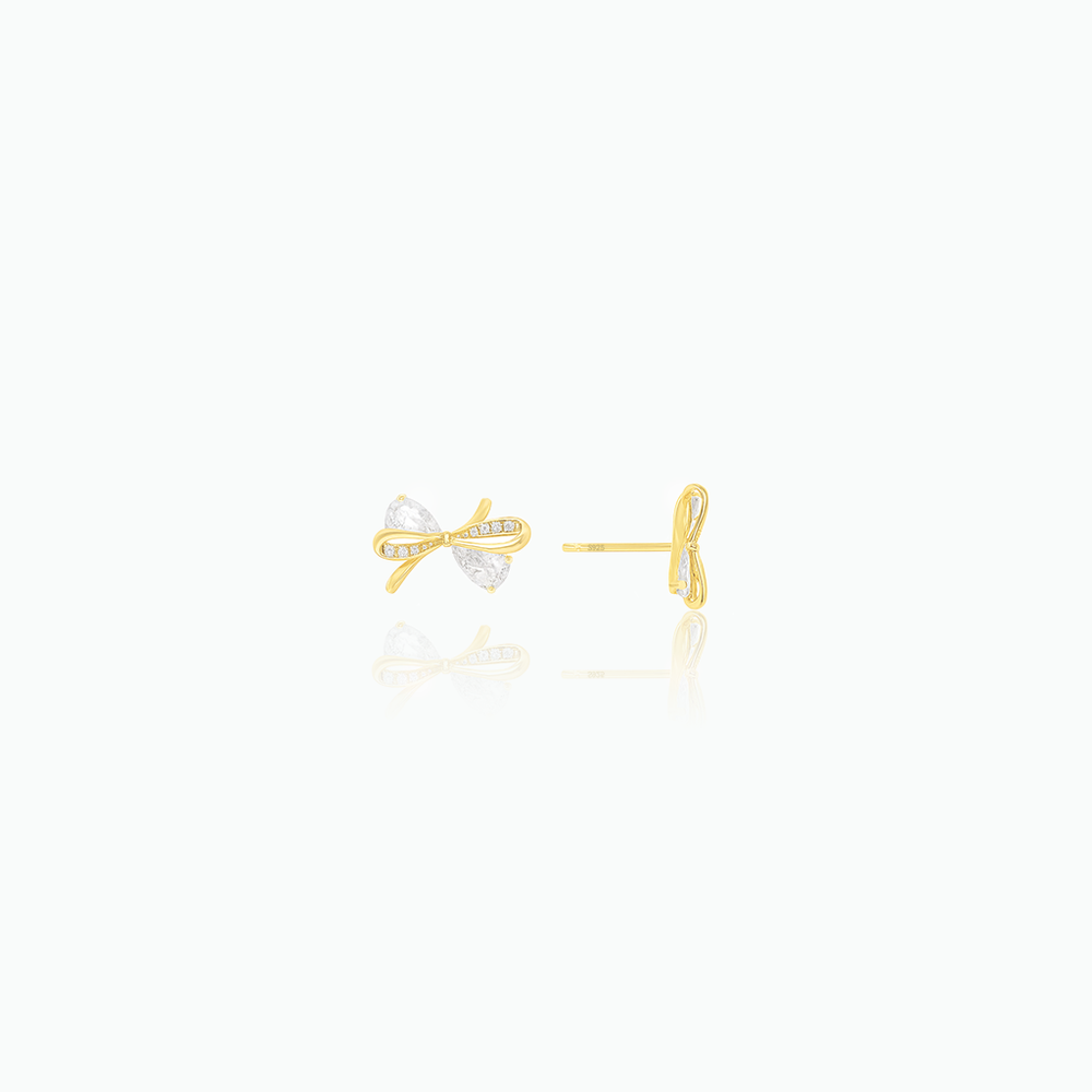 Gold bow-shaped earrings on a white background