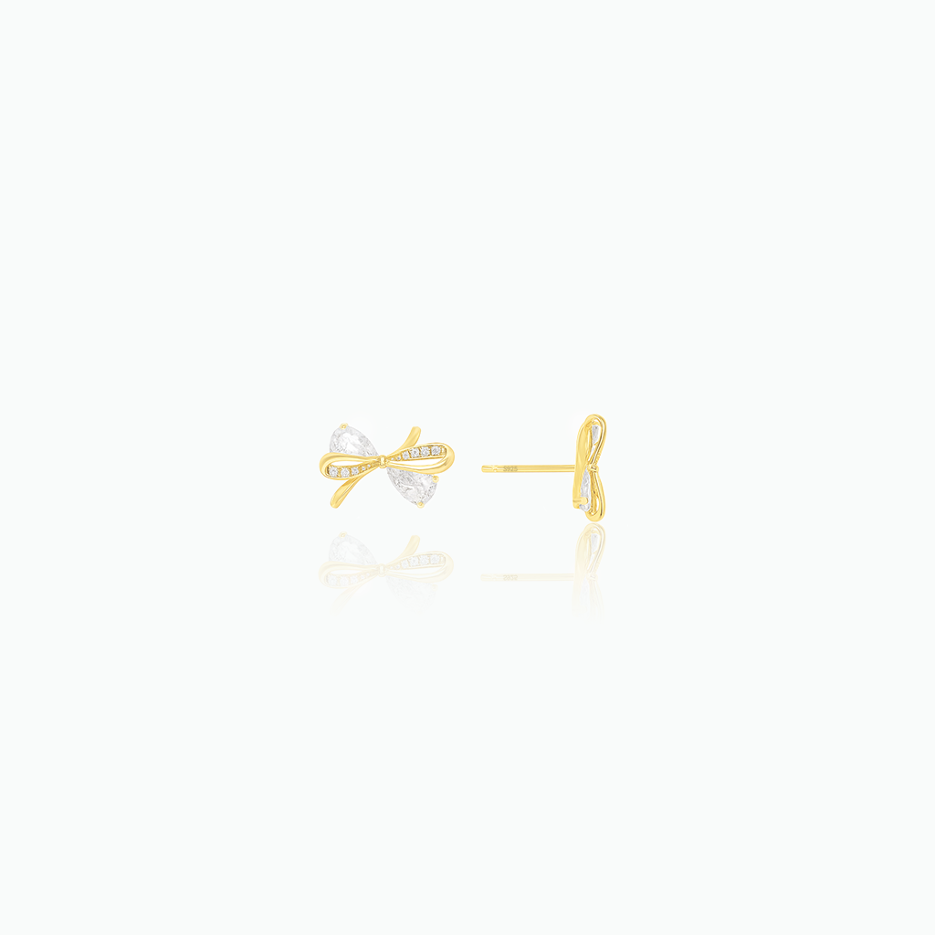 Gold bow-shaped earrings on a white background