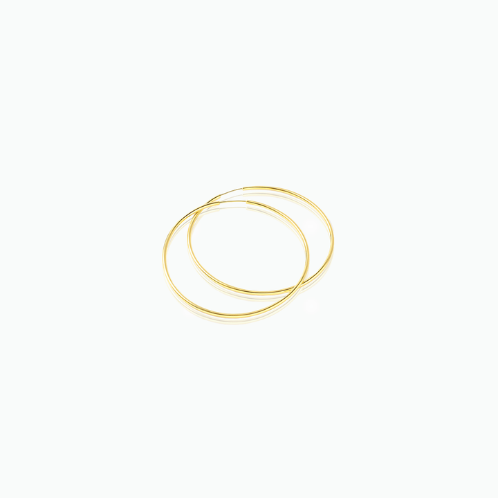 Gold hoop earrings on a white background