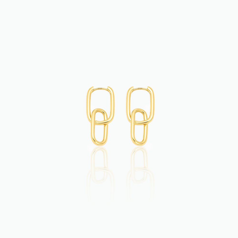 Gold paperclip-style earrings on a white background