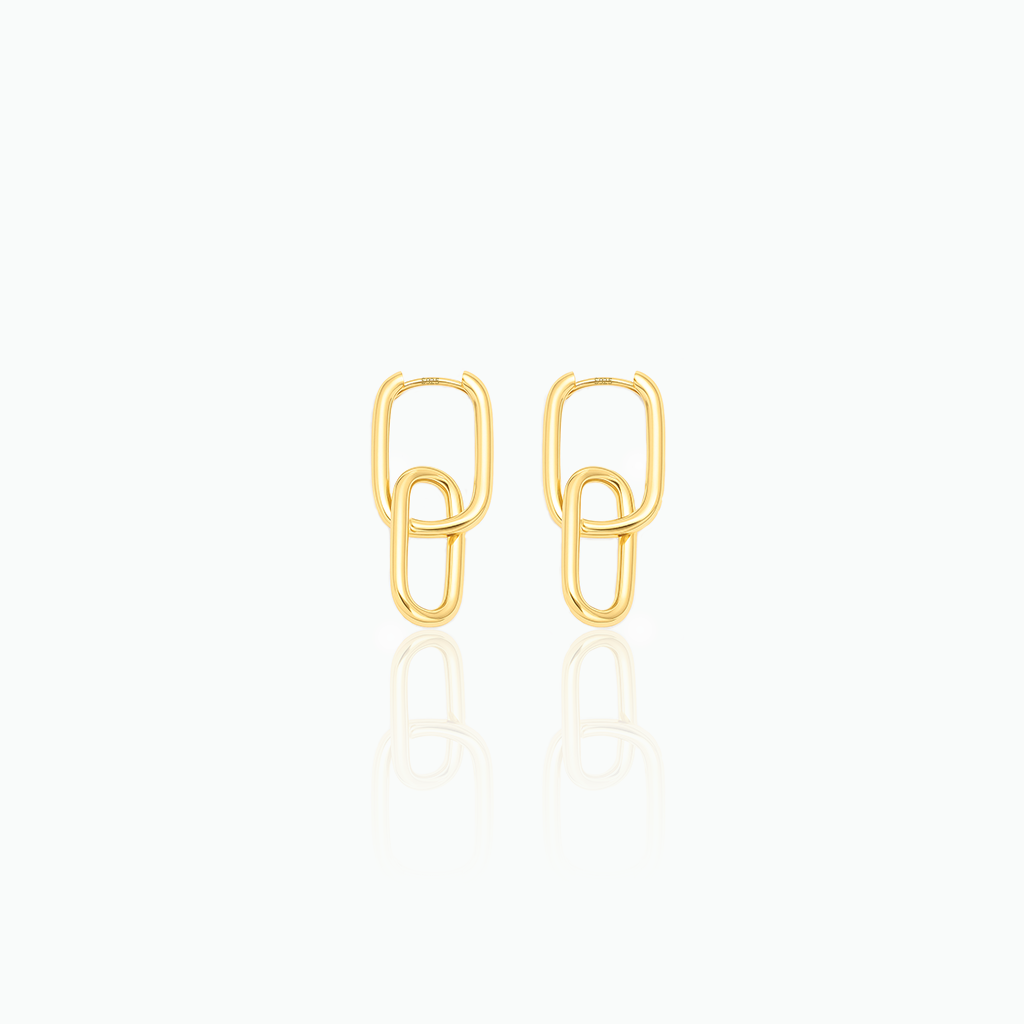 Gold paperclip-style earrings on a white background