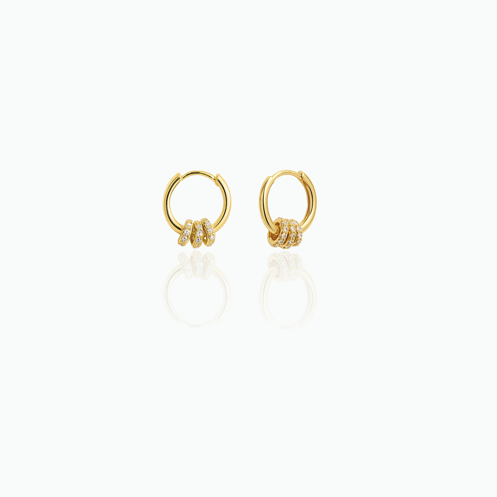 Gold hoop earrings with small diamonds on a white background
