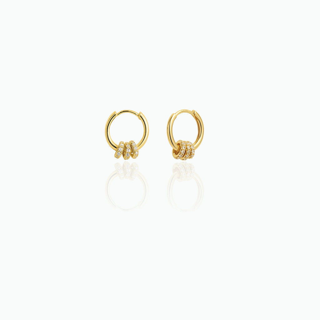 Gold hoop earrings with small diamonds on a white background