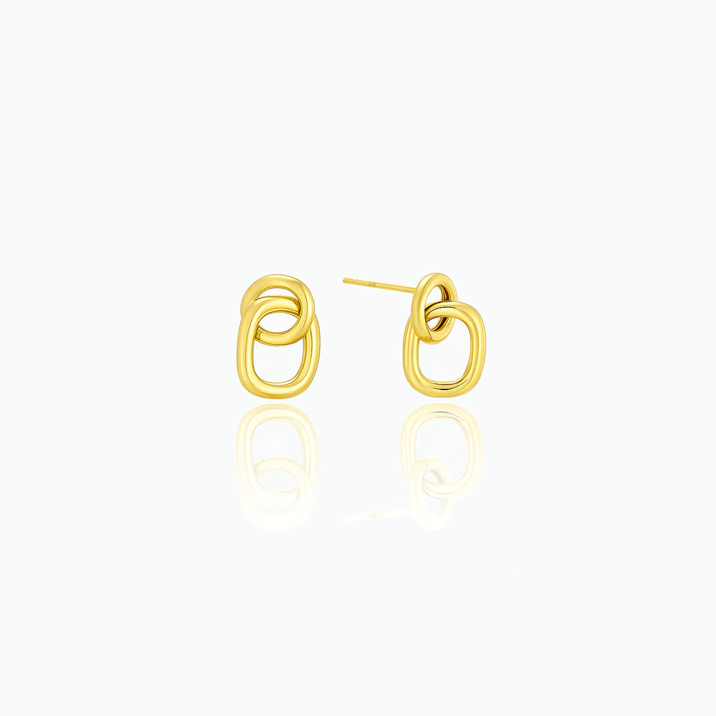 Gold earrings on a white background