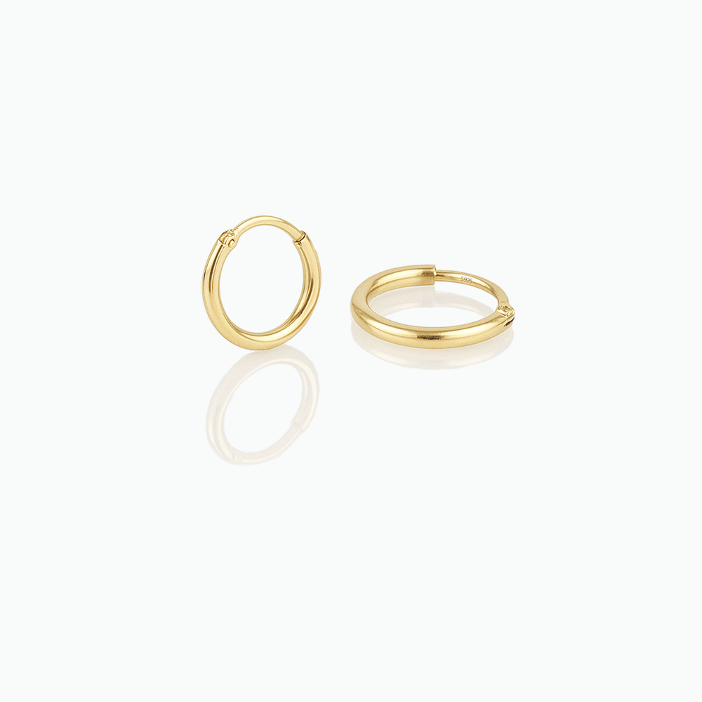 Gold hoop earrings on a white background