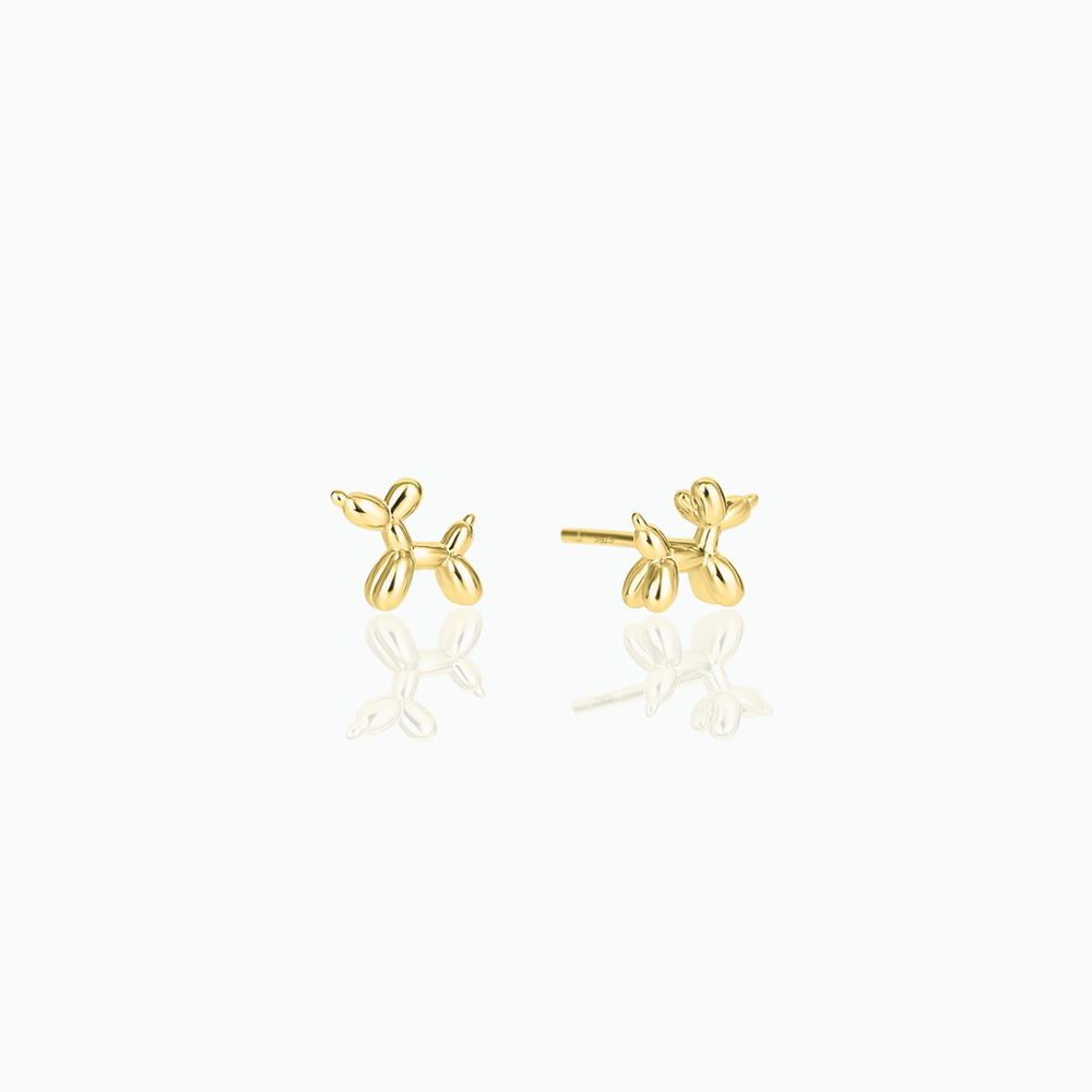 Gold balloon dog-shaped earrings on a white background