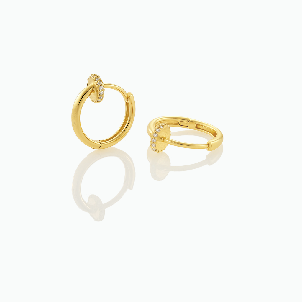 Gold hoop earrings on a white background