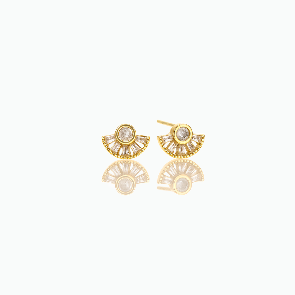 Gold earrings with a diamond center on a white background