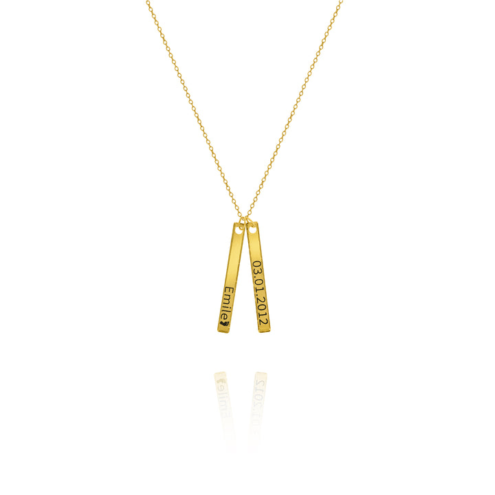 A personalized hammered bar necklace with the words engraved on each bar, suspended on a gold chain against a white background.