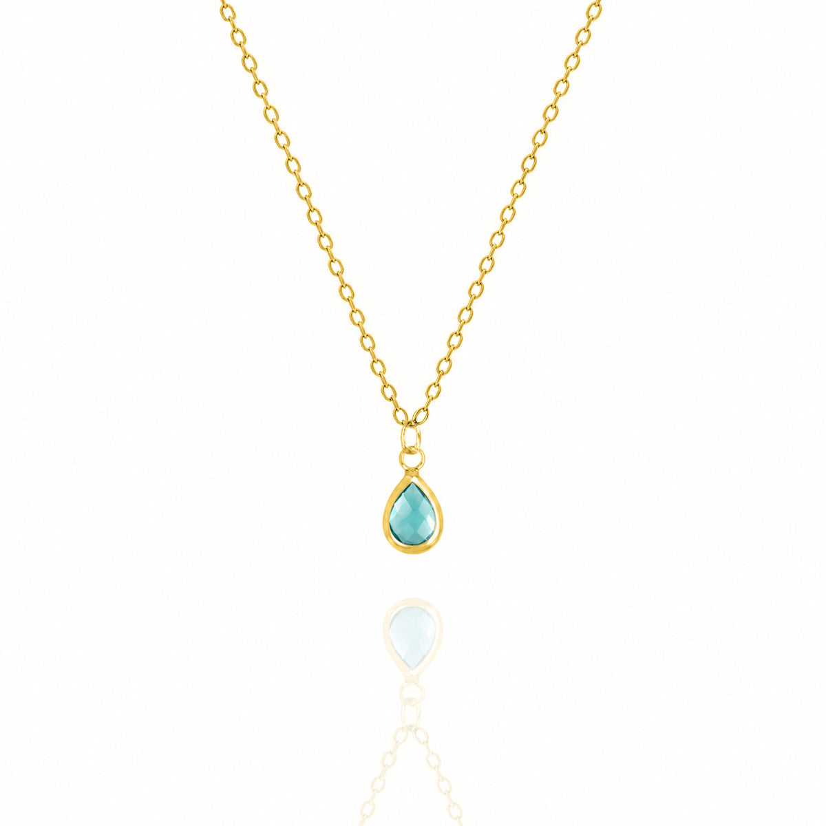 Gold-tone necklace with a light blue teardrop pendant on a white background