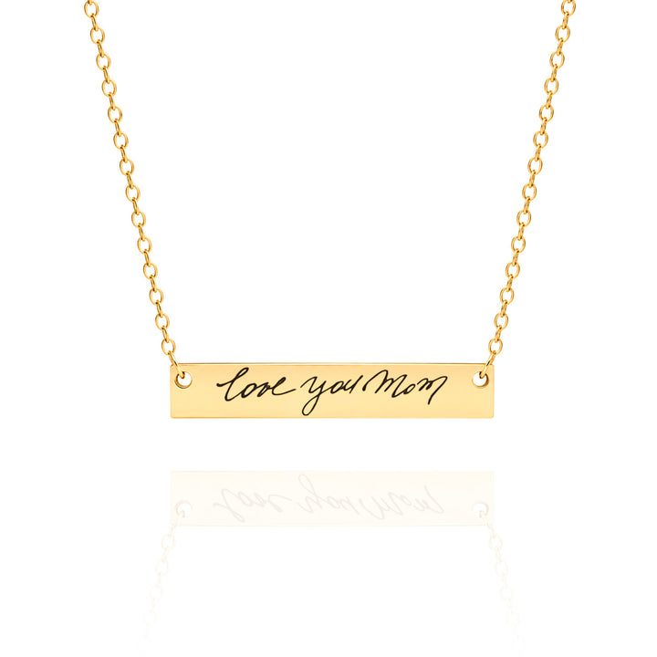Gold necklace with 'love you Mom' pendant on a white background