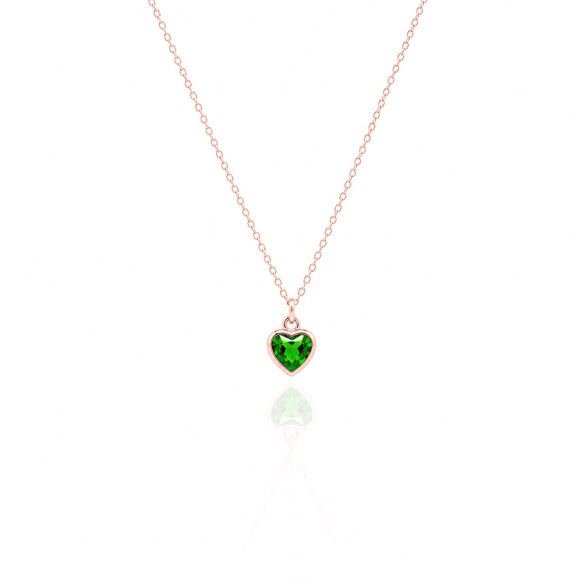 Heart-shaped green gemstone pendant on a rose gold chain against a white background