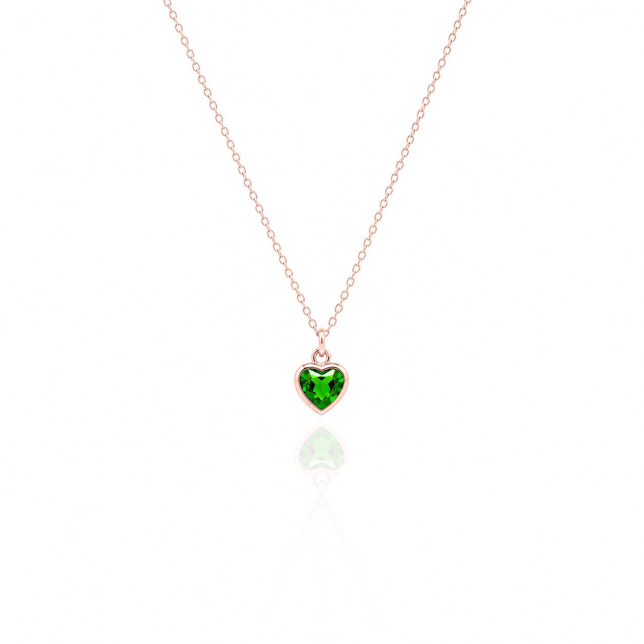 Heart-shaped green gemstone pendant on a rose gold chain against a white background