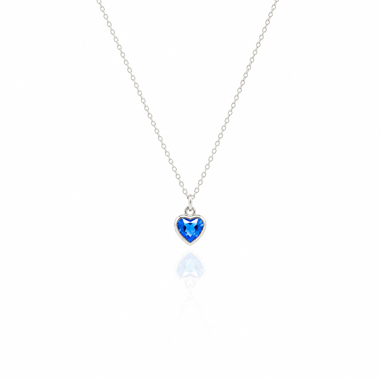 Heart-shaped blue gemstone necklace on a white background