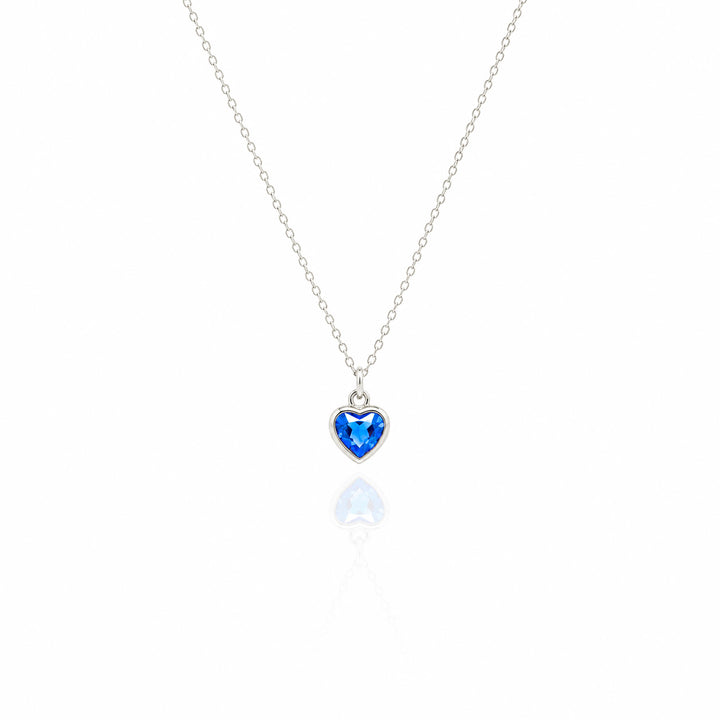Heart-shaped blue gemstone necklace on a white background