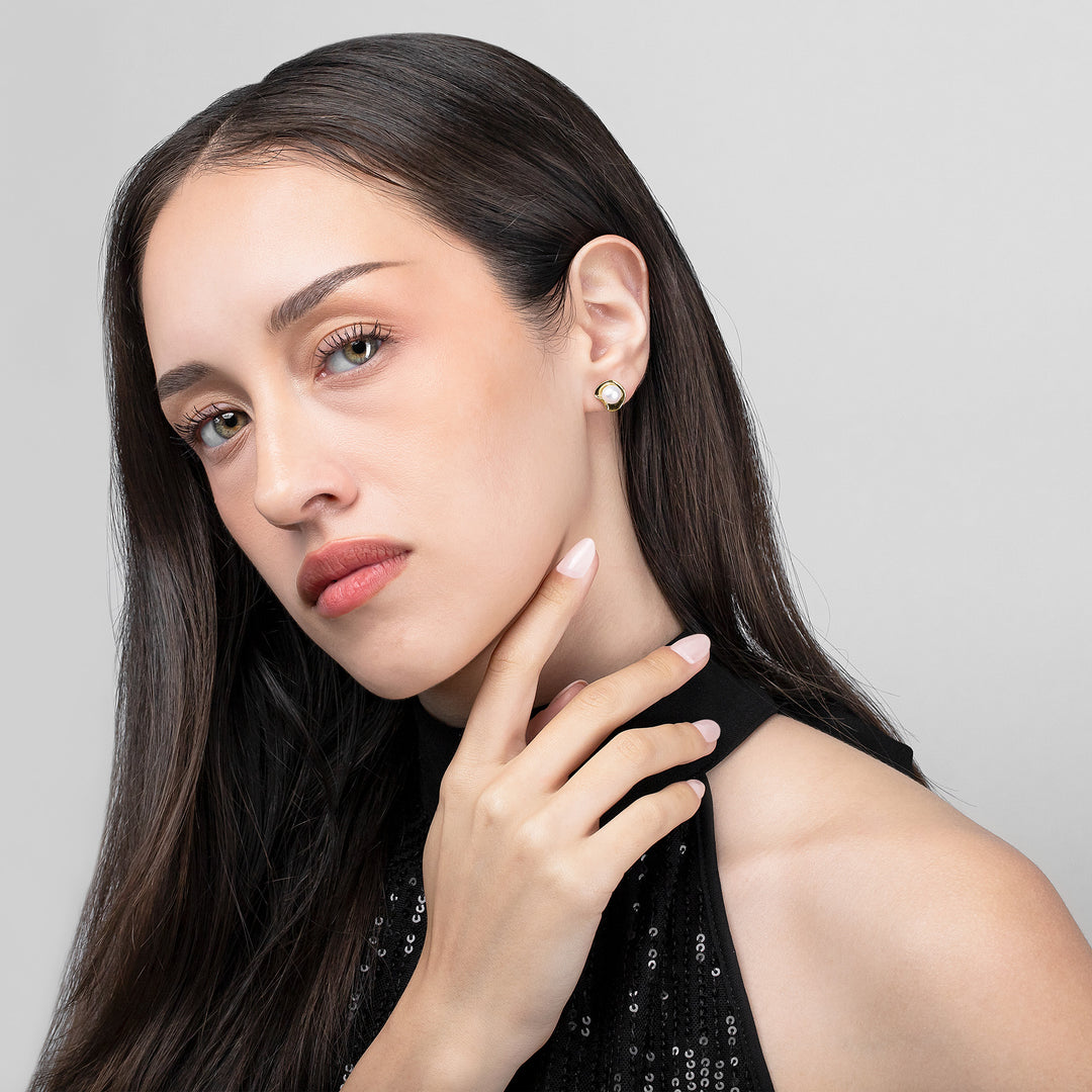 Woman wearing earrings with a neutral background