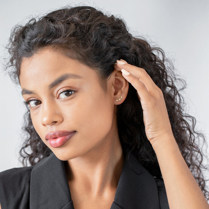 Woman adjusting her hair with a neutral background