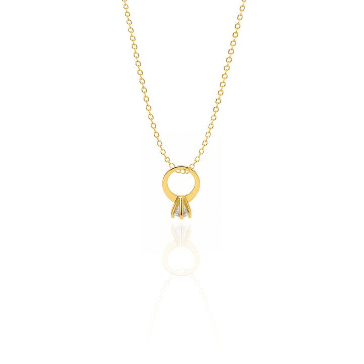 Gold necklace with a circular pendant on a white background