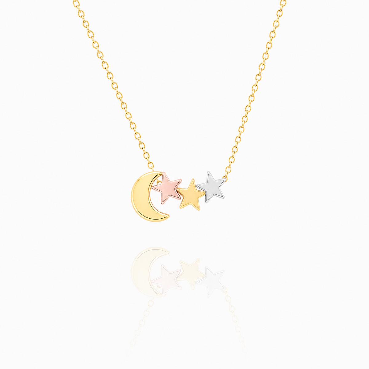 Gold-tone necklace with a crescent moon and three star charms in mixed metal tones on a white background