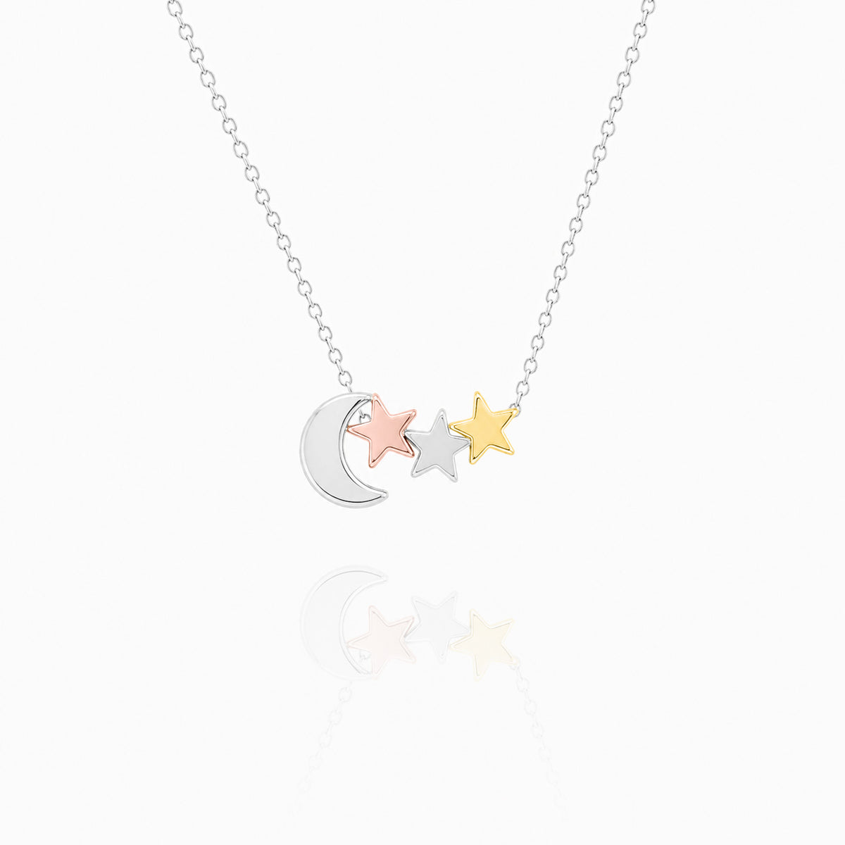 Silver-tone necklace with a crescent moon and three star charms in mixed metal tones on a white background