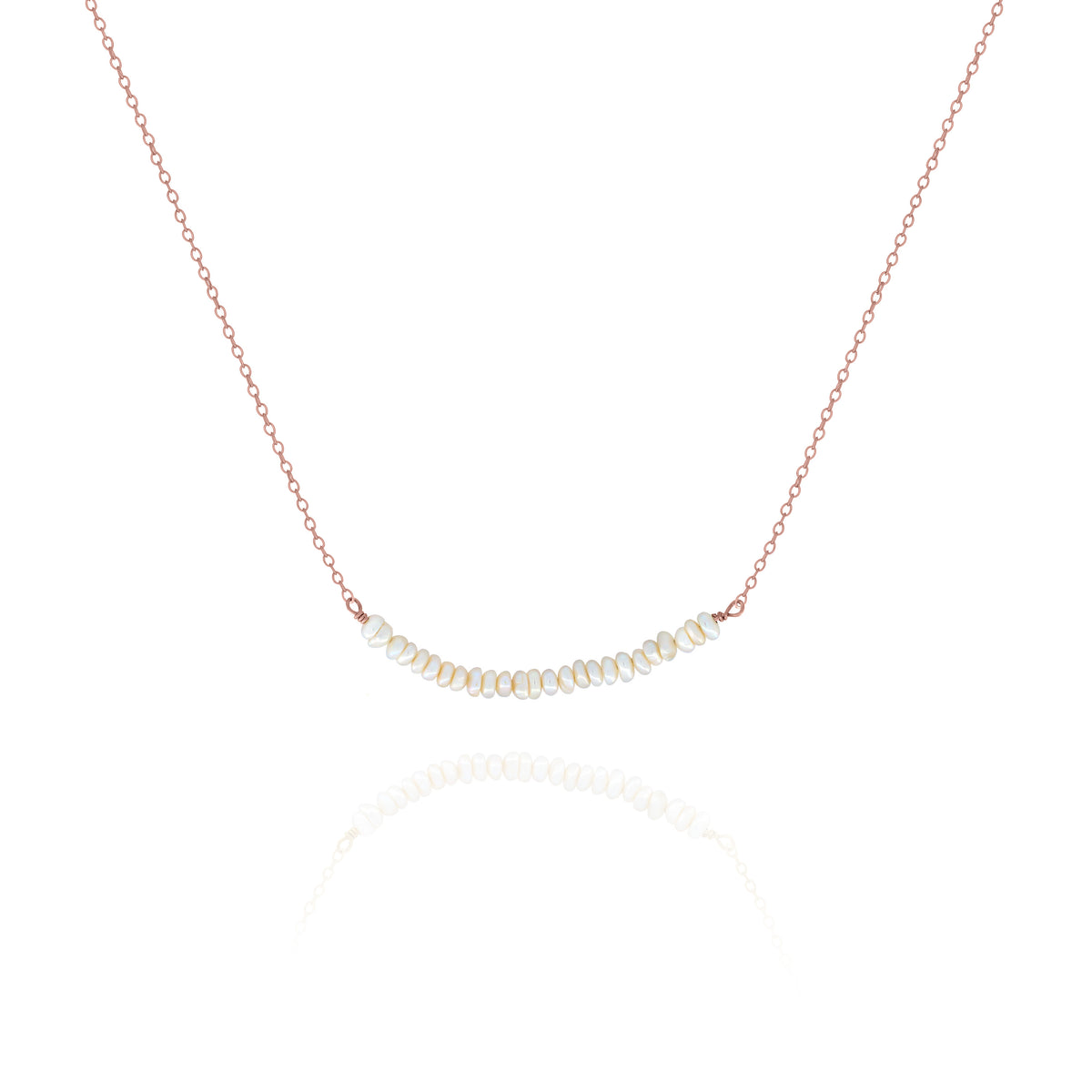 Rose-gold-tone necklace with a centered row of small white pearls on a white background