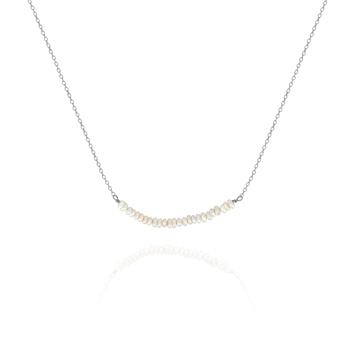 Silver-tone necklace with a centered row of small white pearls on a white background