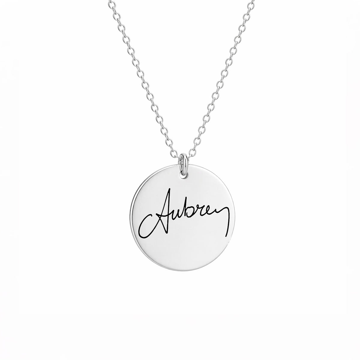 Silver-tone round pendant necklace engraved Aubrey in handwritten script on a white background