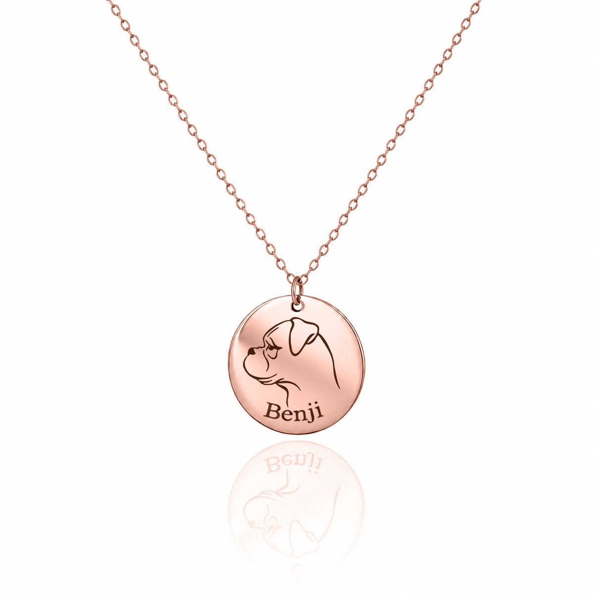 Rose-gold-tone round pendant necklace engraved with a dog profile and the name Benji on a white background