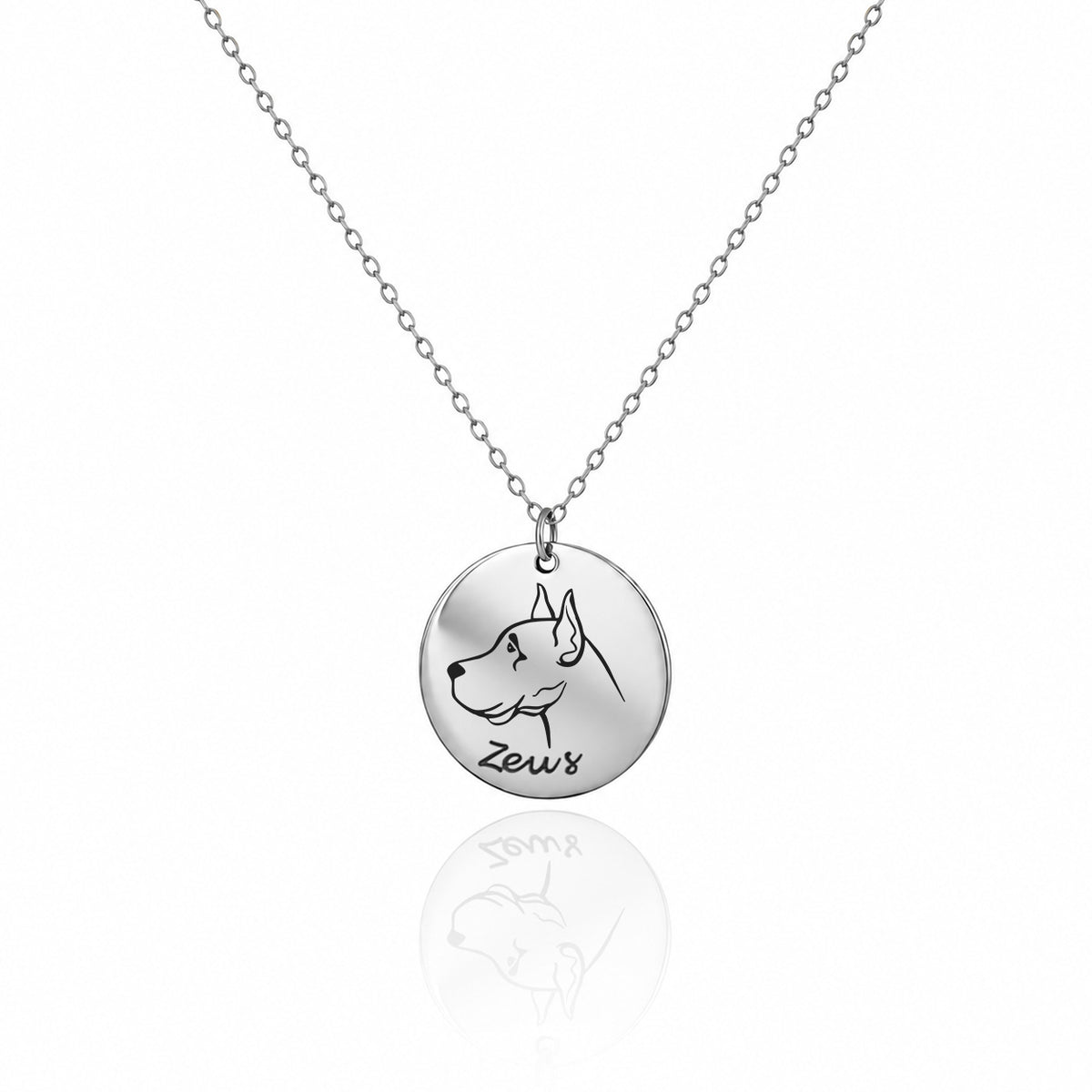 Silver-tone round pendant necklace engraved with a dog profile and the name Zeus on a white background