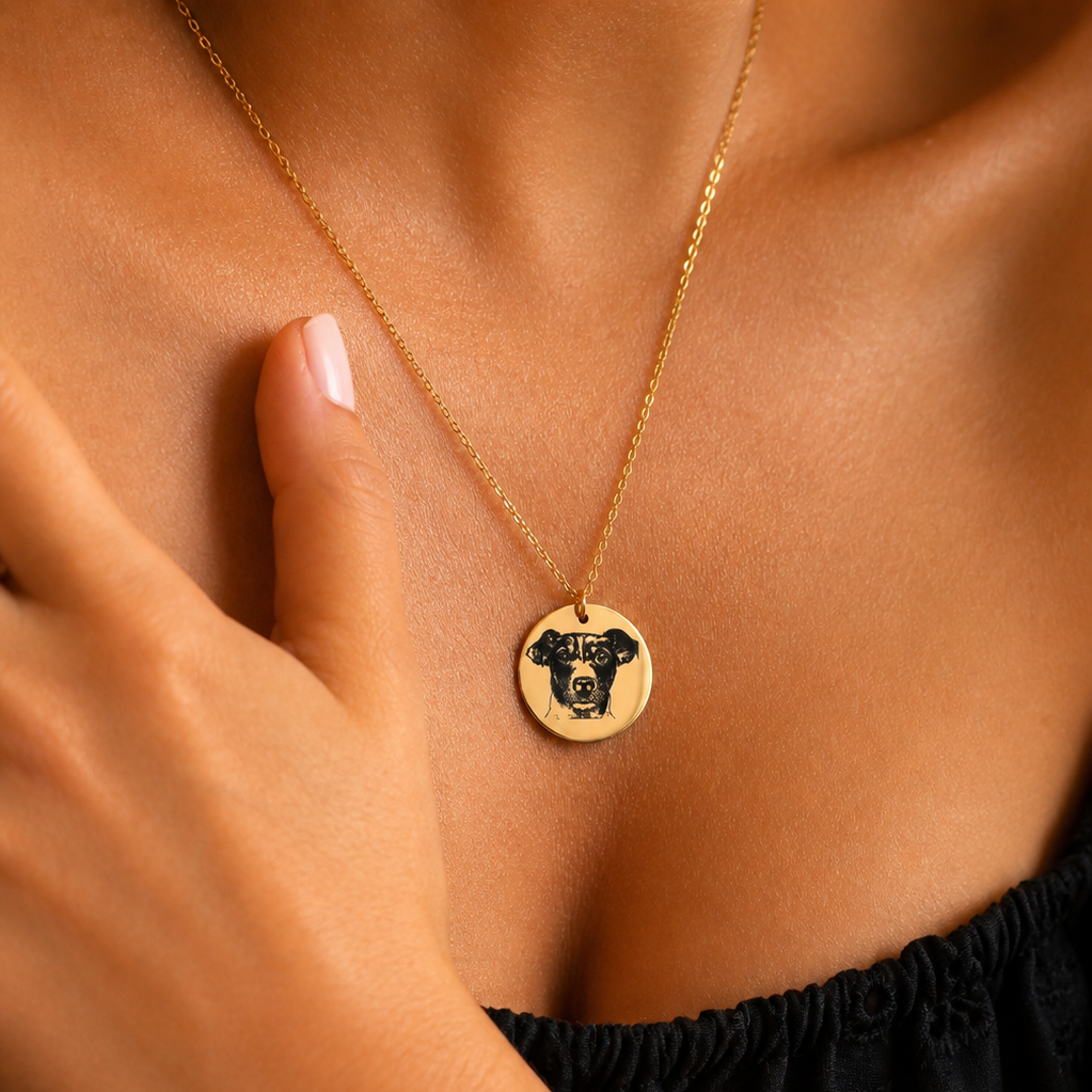 Gold-tone round pendant necklace featuring a dog portrait worn at the neckline