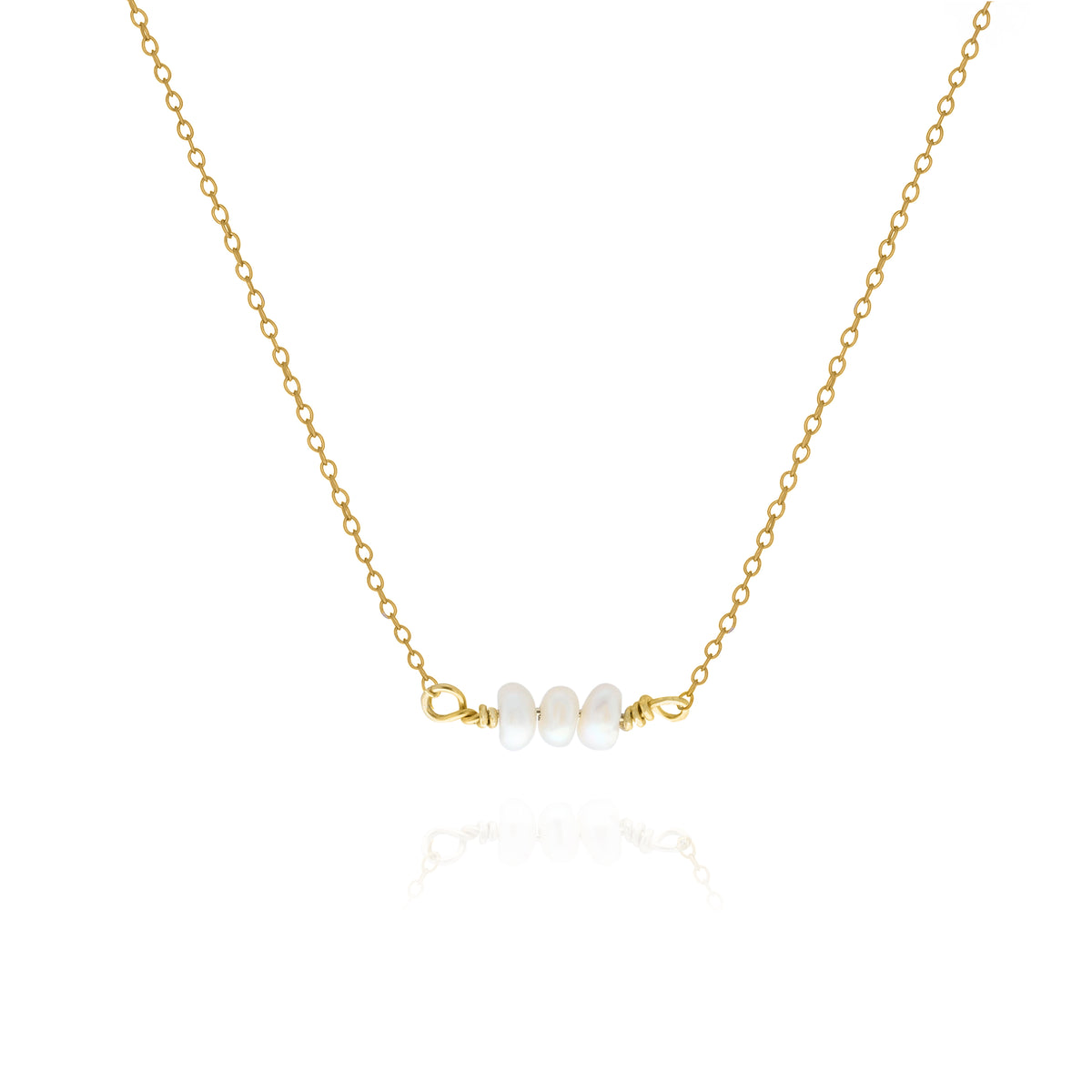 Gold-tone necklace with a short row of white oval pearls on a white background