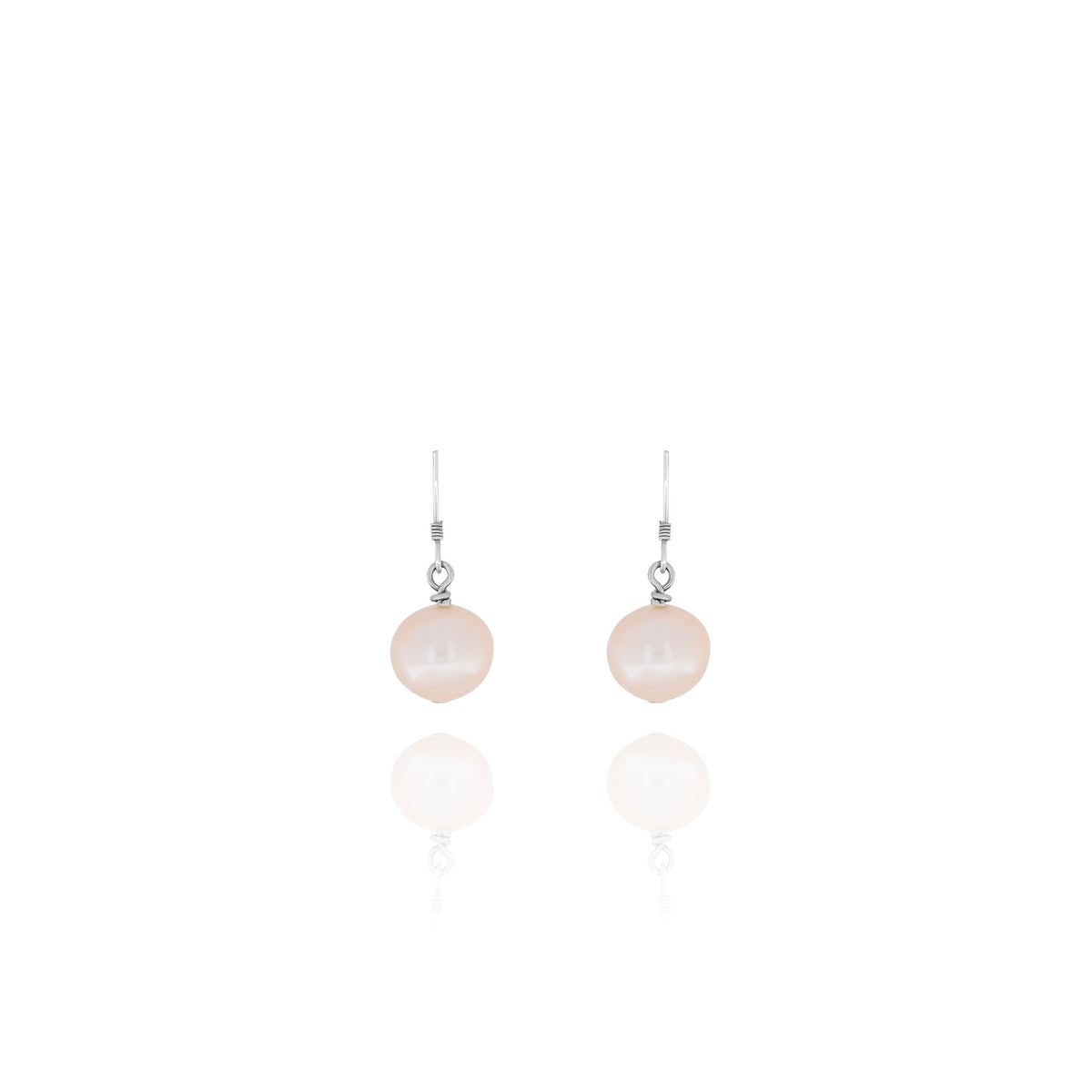 Pair of silver-tone dangle earrings with pale peach rounded drops on a white background