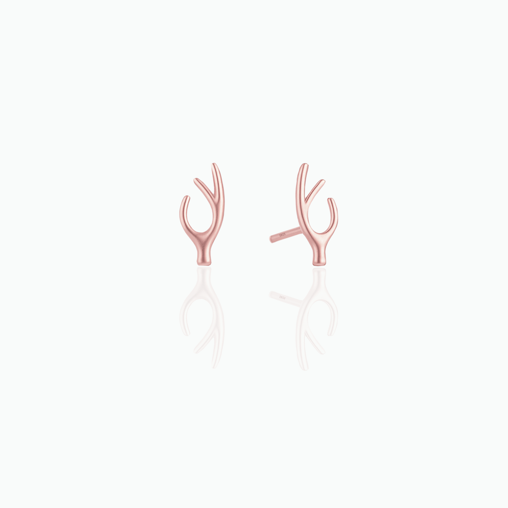 Rose gold earrings on a white background
