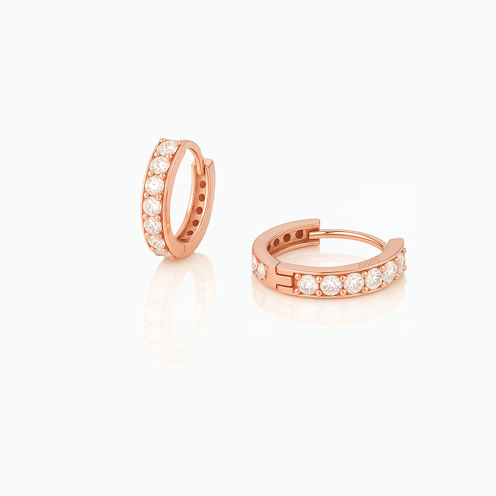 Rose gold hoop earrings with embedded diamonds on a white background