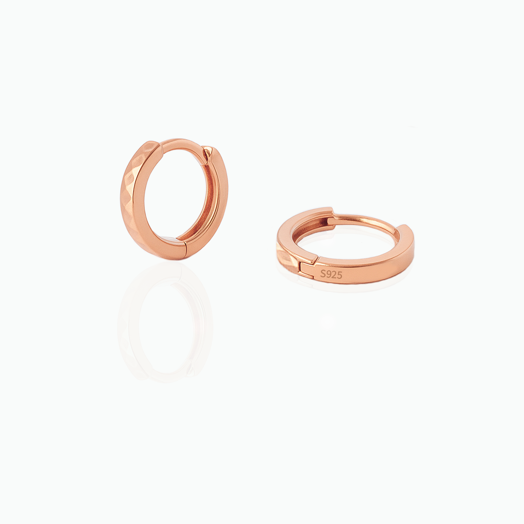 Rose gold hoop earrings on a white background