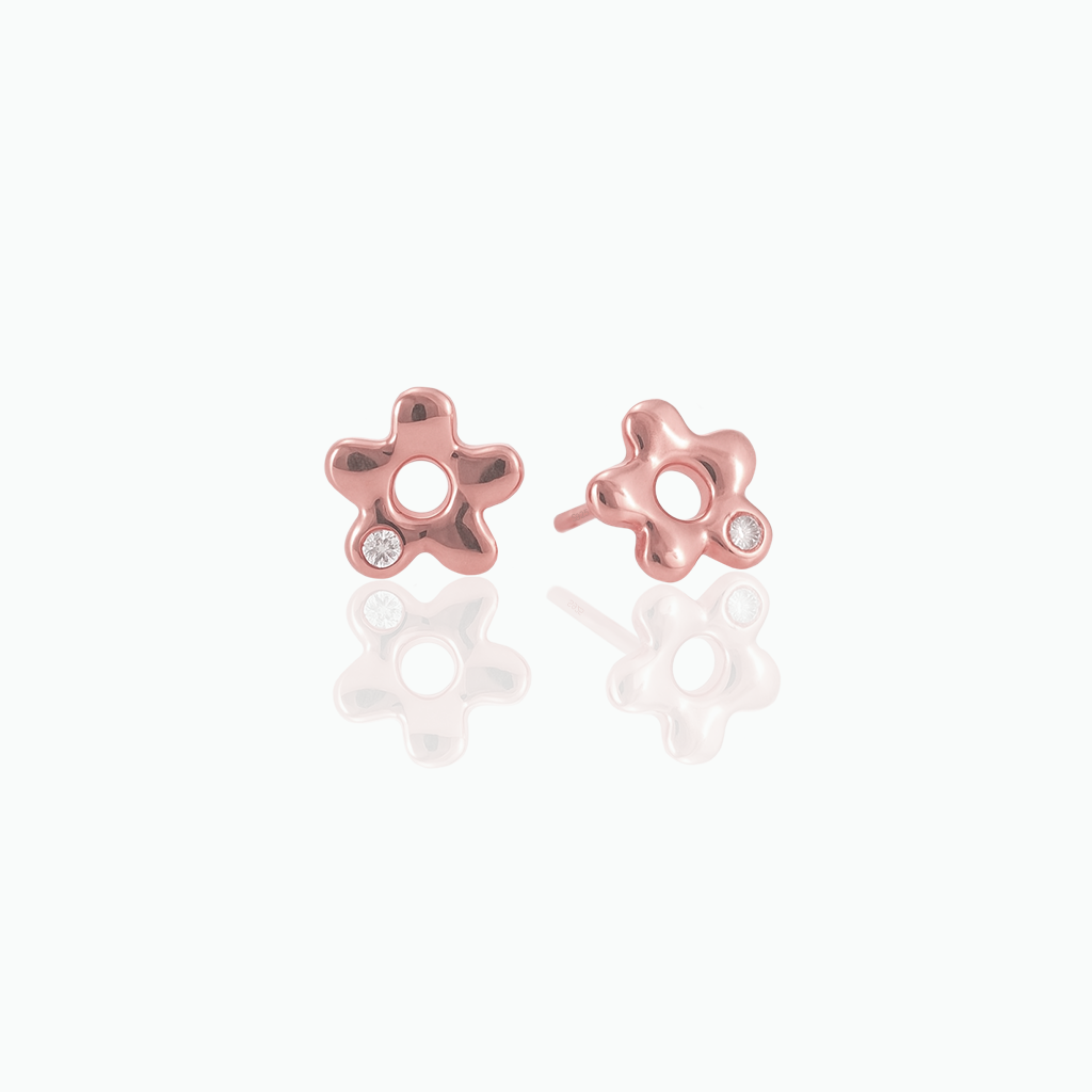 Rose gold-tone flower stud earrings with clear stone accents displayed on a white background