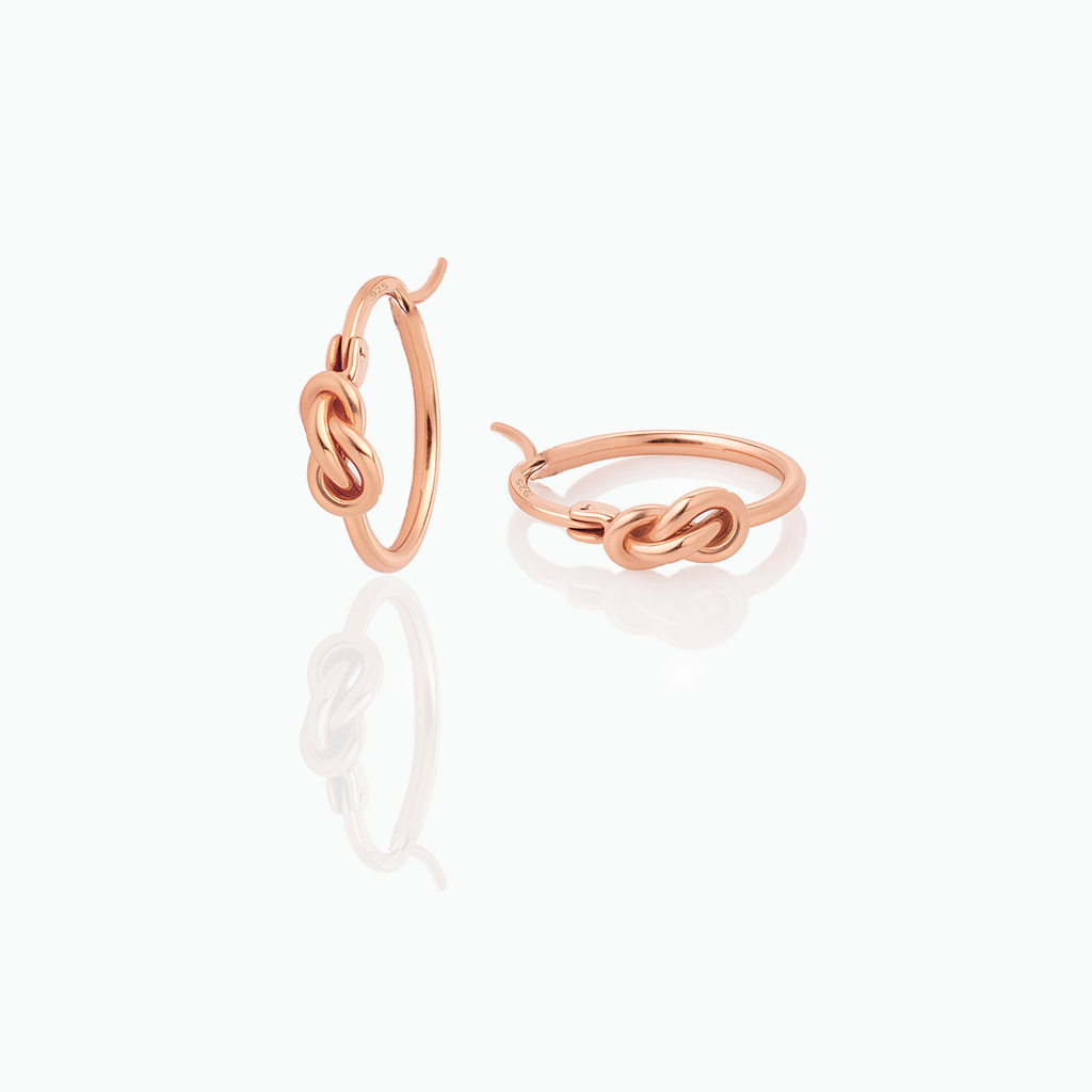 Rose gold hoop earrings on a white background