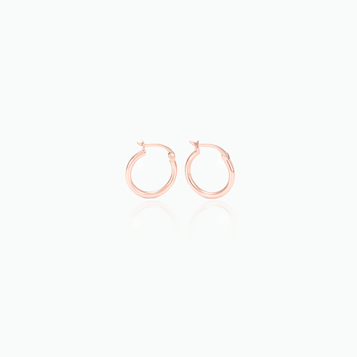 Rose gold hoop earrings on a white background