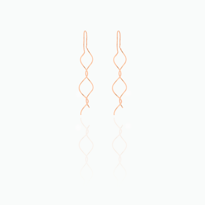 Pair of rose gold earrings on a white background