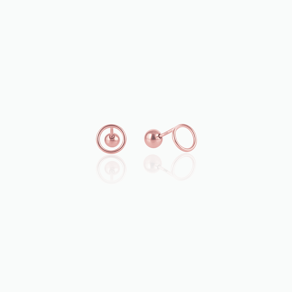 Pair of rose gold earrings on a white background
