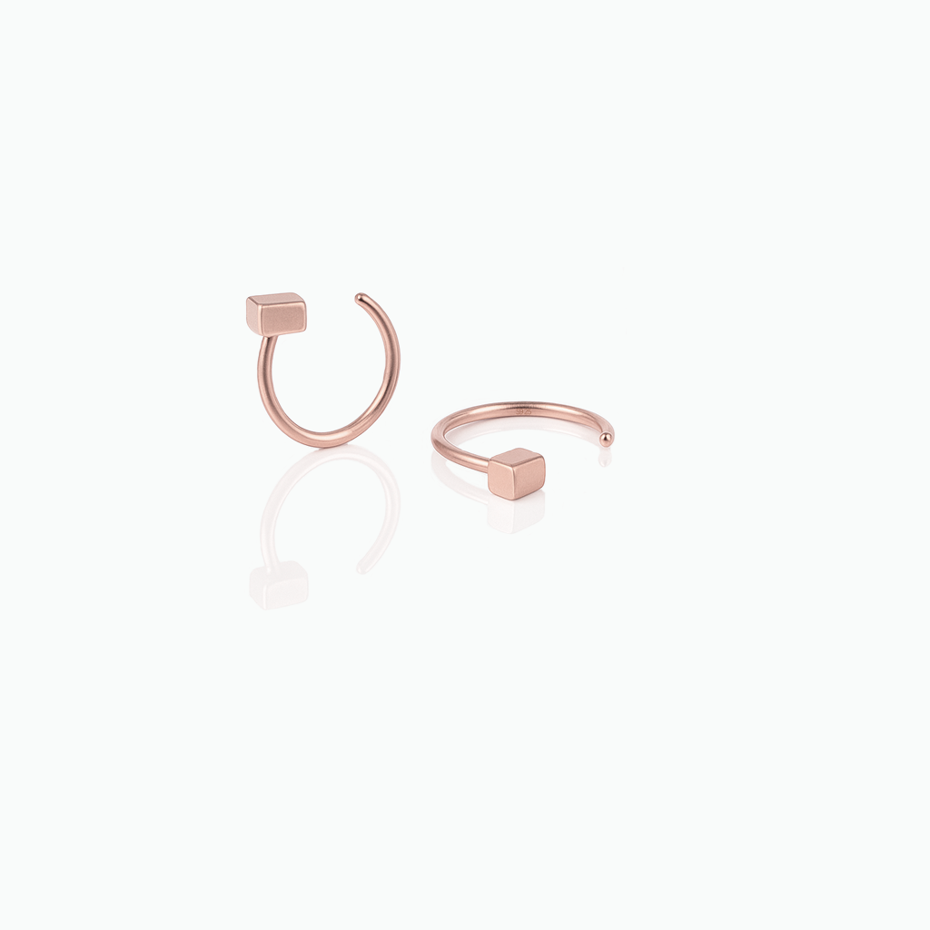 Rose gold hoop earrings on a white background