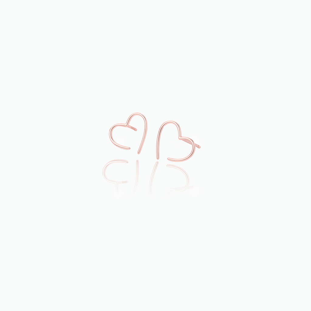 Rose gold heart-shaped earrings on a white background