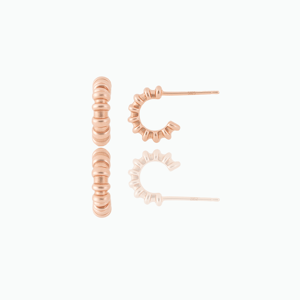 Rose gold hoop earrings on a white background