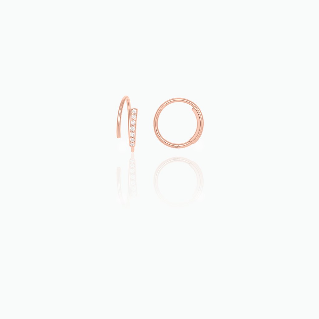 Rose gold hoop earrings with small diamonds on a white background