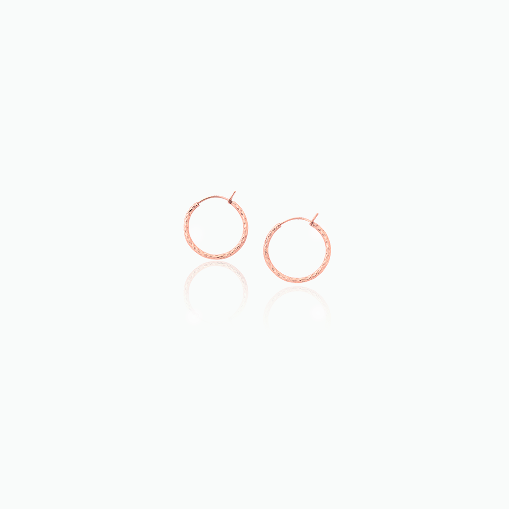 Rose gold hoop earrings on a white background
