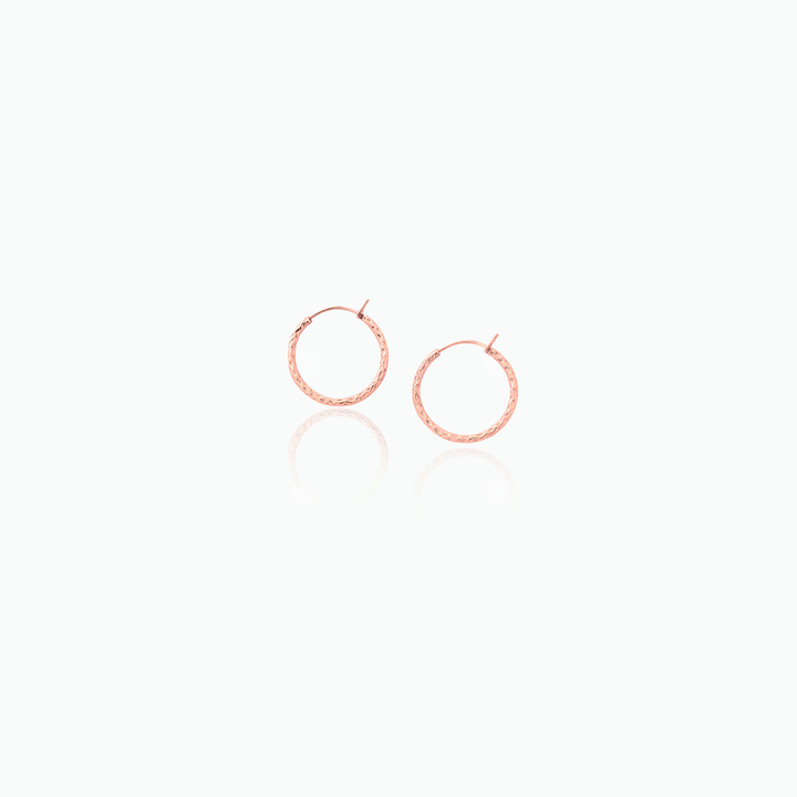 Rose gold hoop earrings on a white background