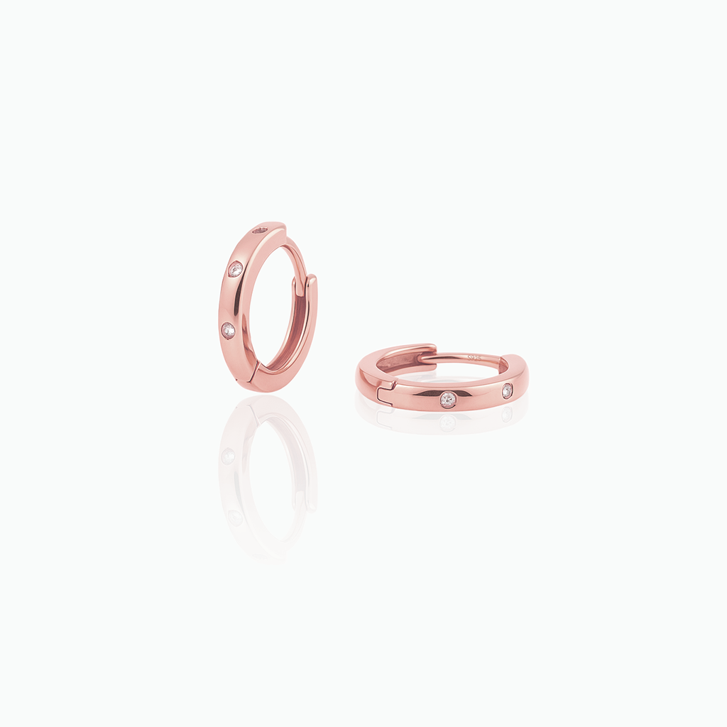 Rose gold hoop earrings on a white background