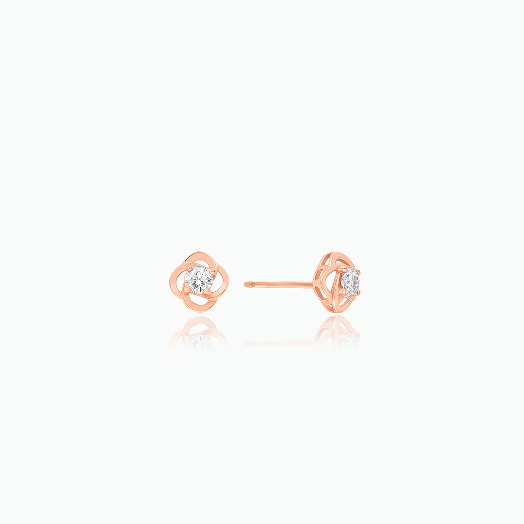 Rose gold earrings with small diamonds on a white background
