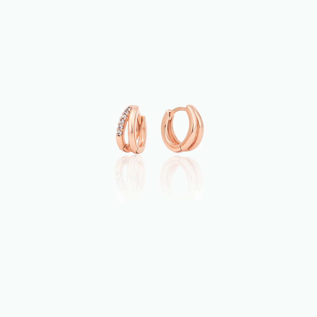 Rose gold hoop earrings on a white background