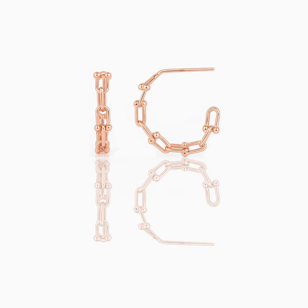 A pair of delicate huggie earrings made of gold vermeil, displayed against a white background.